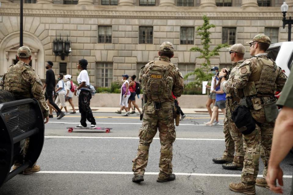 Customs and Border Protection police watch as demonstrators protest in Washington over the death of George Floyd.