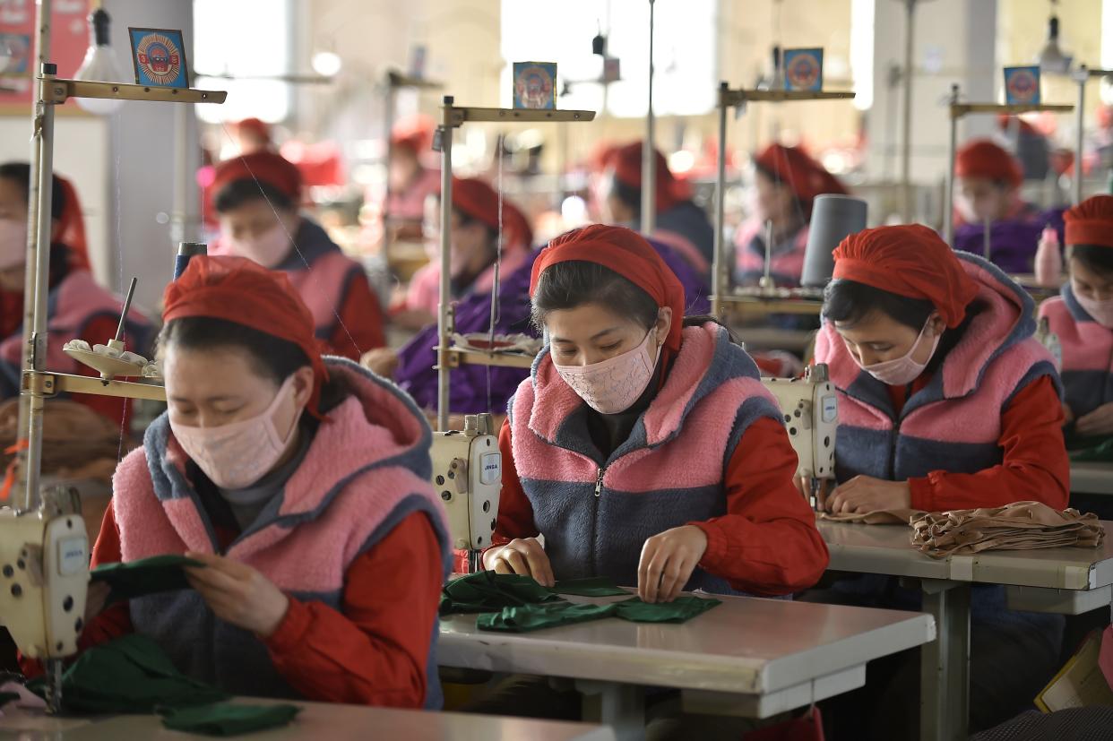 In this photo taken on February 6, 2020, workers of Songyo Knitwear Factory in Pyongyang produce masks for protection against the new coronavirus. - At least 31,000 people have been infected and more than 630 killed by the virus following the outbreak which began in the Chinese city of Wuhan, which has spread to two dozen countries. (Photo by Kim Won-Jin / AFP) (Photo by KIM WON-JIN/AFP via Getty Images)