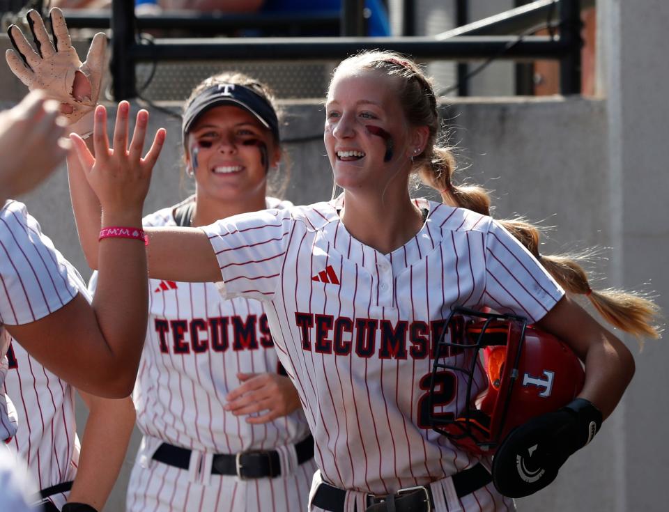 Tecumseh Braves Katelyn Marx (2) high-fives teammates in the dugout during the IHSAA Class 1A Softball State Final against the Caston Comets, Saturday, June 10, 2023, at Purdue University’s Bittinger Stadium in West Lafayette, Ind. Tecumseh won 6-0.