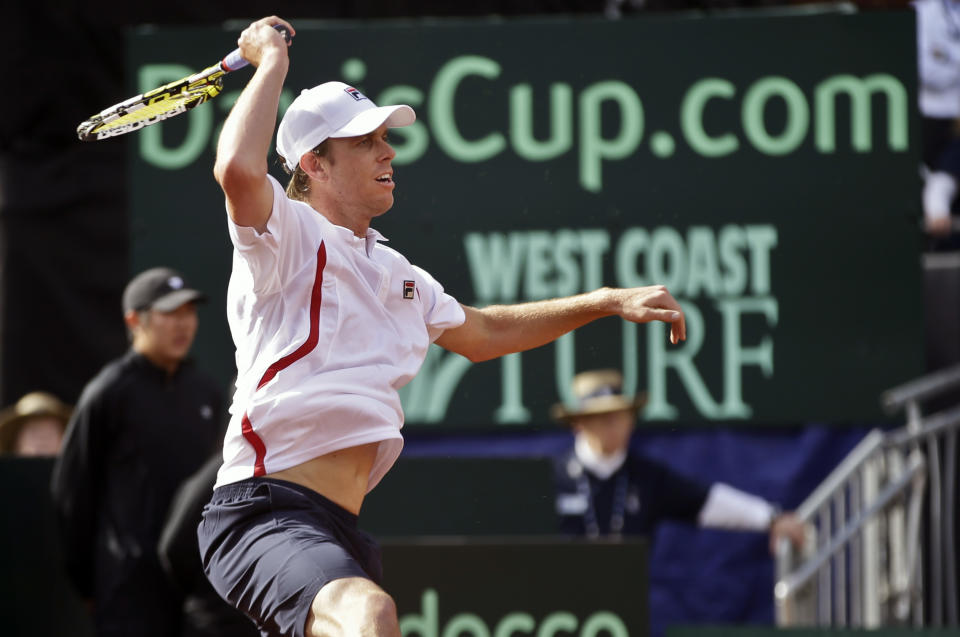 Sam Querrey returns a shot against Britain's James Ward during a Davis Cup tennis match Friday, Jan. 31, 2014, in San Diego. (AP Photo/Lenny Ignelzi)