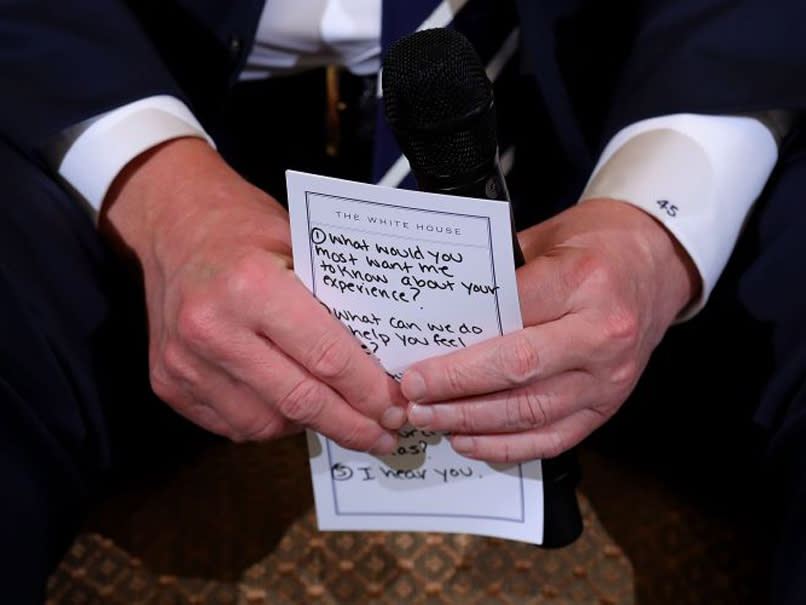 President Donald Trump holds his notes while hosting a listening session with students survivors of mass shootings, their parents and teachers in the State Dining Room at the White House: Getty Images North America