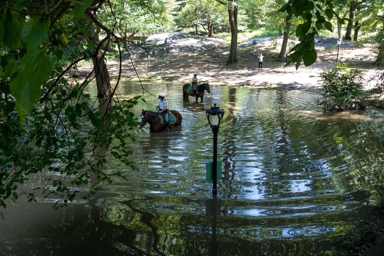 New York City Parks Security Service officers on horseback explore the Greyshot Arch which is flooded in Central Park after a night of extremely heavy rain caused by Hurricane Ida on Sept. 2, 2021, in New York City.