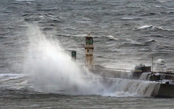 Waves crash over the harbour wall in Dover, south east England on Nov. 20, 2016.