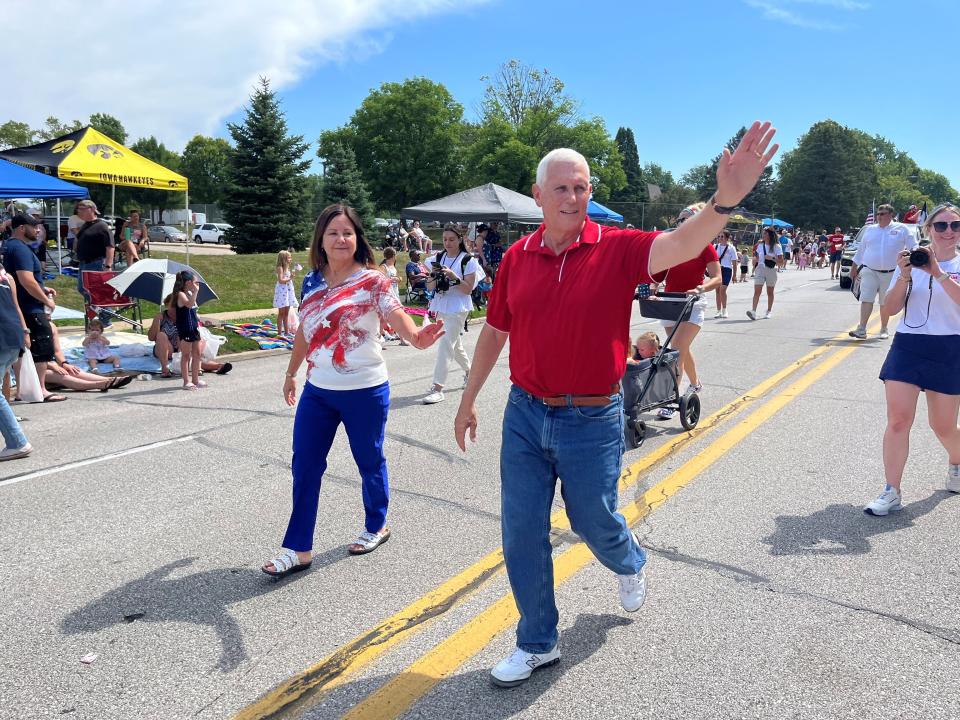 Former Vice President Mike Pence walks in Urbandale's 4th of July parade with his wife, Karen Pence.