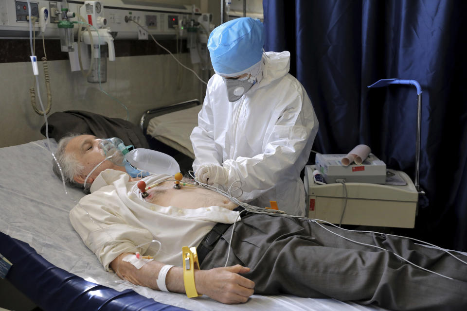 A nurse tends to COVID-19 patient at the Shohadaye Tajrish Hospital in Tehran, Iran, Sunday, April 18, 2021. After facing criticism for downplaying the virus last year, authorities have put partial lockdowns and other measures in place to try and slow the coronavirus’ spread, as Iran faces what looks like its worst wave of the coronavirus pandemic yet. (AP Photo/Ebrahim Noroozi)