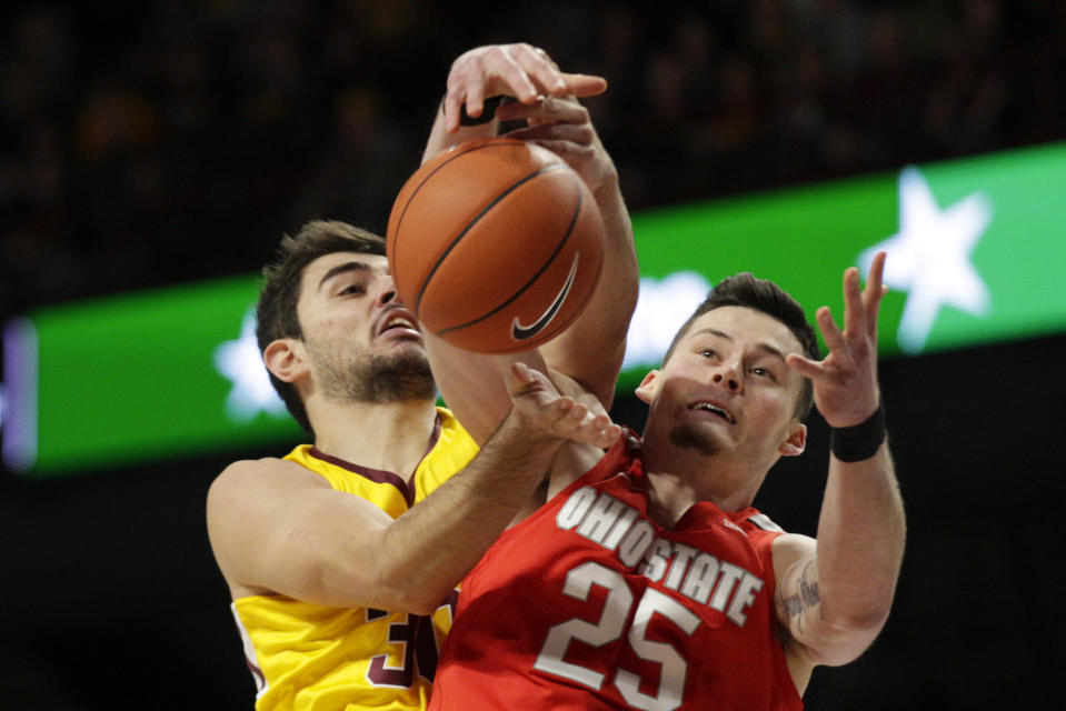 Minnesota forward Alihan Demir (30) and Ohio State forward Kyle Young (25) battle for a rebound in the first half of an NCAA basketball game Sunday, Dec. 15, 2019, in Minneapolis. (AP Photo/Andy Clayton-King)