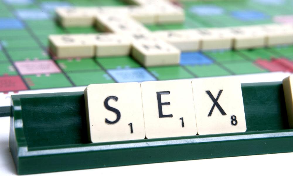 The word sex spelled out on a Scrabble board.