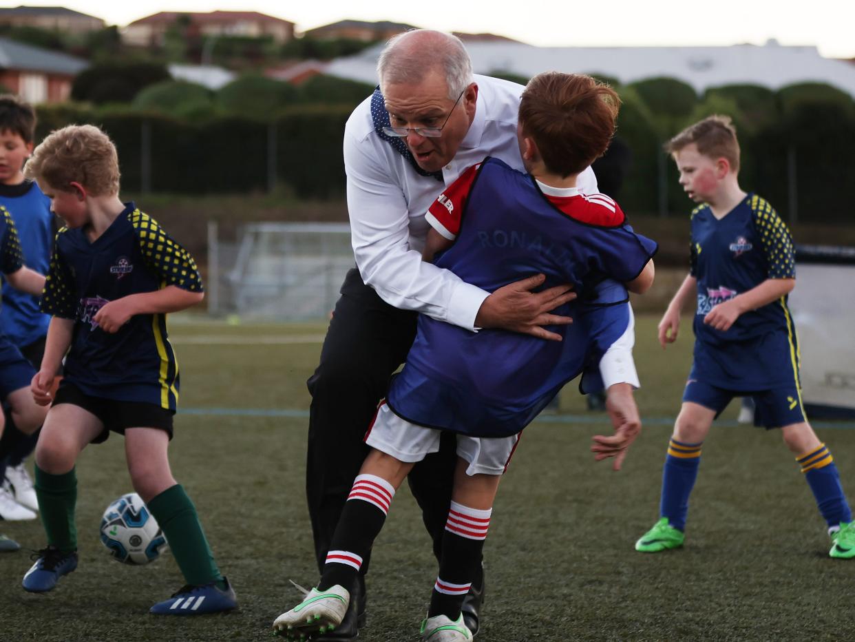 rime Minister Scott Morrison accidentally knocks over a child during a visit to the Devonport Strikers Soccer Club, which is in the electorate of Braddon, on May 18, 2022 in Devonport, Australia.