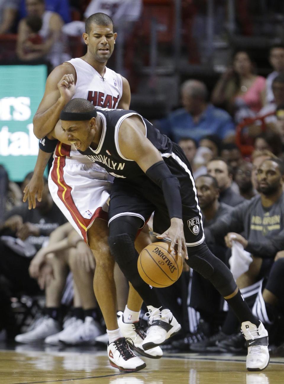 Brooklyn Nets forward Paul Pierce drives around Miami Heat forward Shane Battier during the first half of an NBA basketball game, Tuesday, April 8, 2014 in Miami. (AP Photo/Wilfredo Lee)