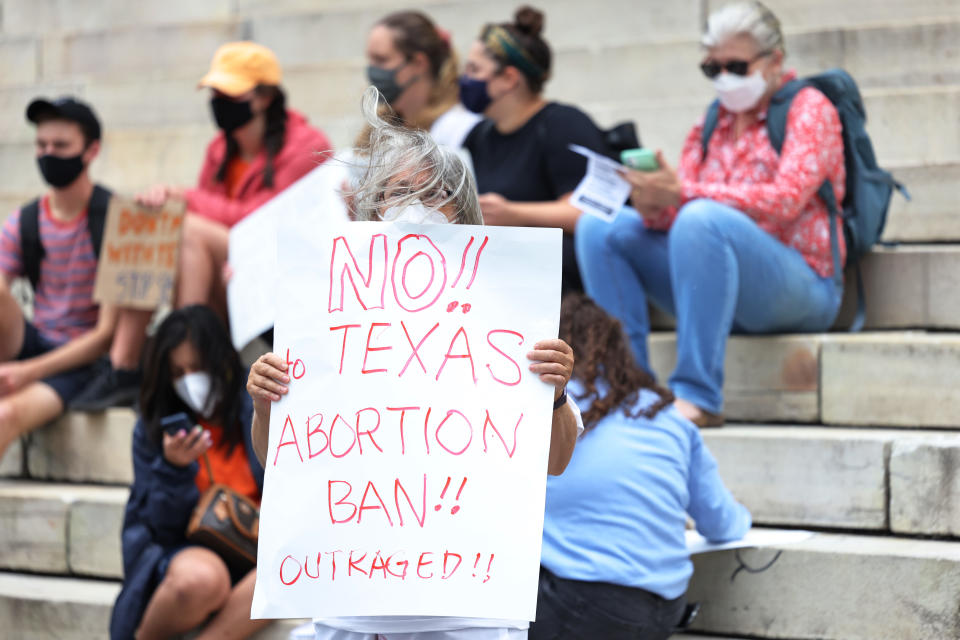 Debra Sweet joins people gathered for a reproductive rights rally at Brooklyn Borough Hall on Sept. 1 in downtown Brooklyn in New York City. She holds a sign saying: 