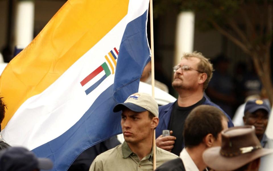 The apartheid-era South African national flag is flown by a supporter of the Afrikaner Resistance Movement (AWB) in 2010 - REUTERS