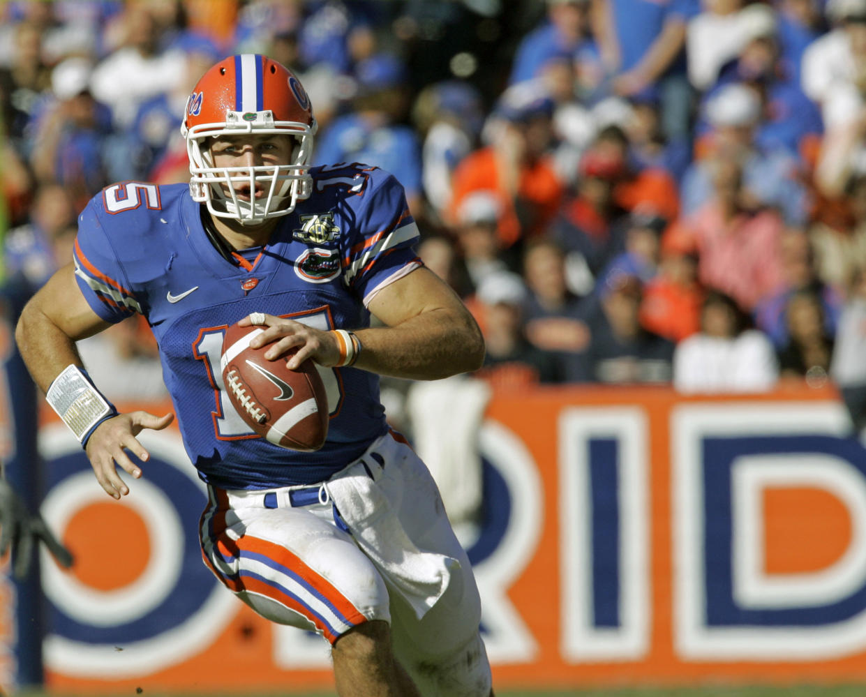 FILE - In this Nov. 17, 2007, file photo, Florida quarterback Tim Tebow scrambles during the second half of a football game against Florida Atlantic in Gainesville, Fla. Tebow was elected to the College Football Hall of Fame, Monday, Jan. 9, 2023. (AP Photo/John Raoux)