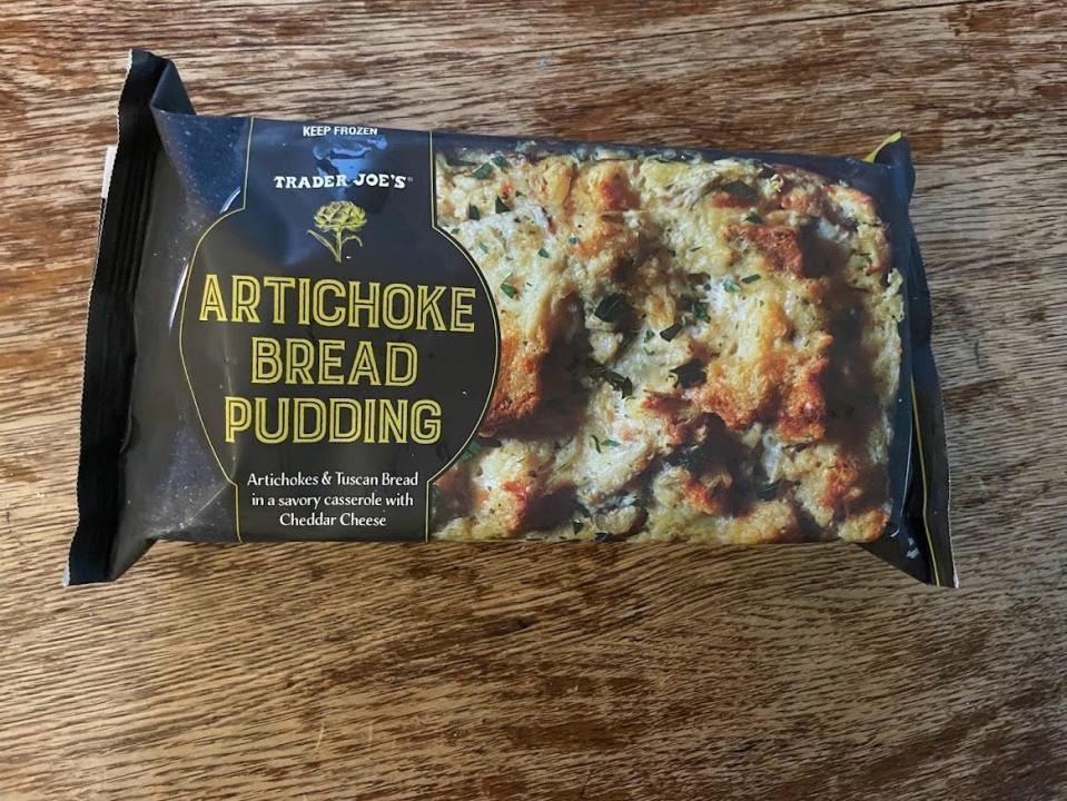 Black package of Trader Joe's artichoke bread budding on wooden counter