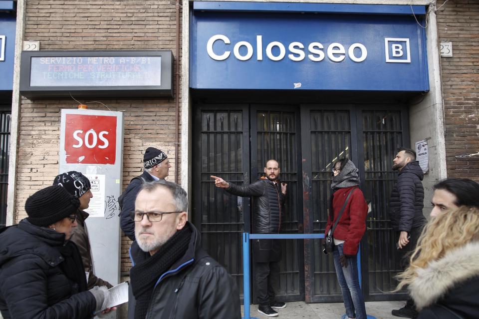 A man gives indications to tourists after the Colosseo subway station was closed following three earthquakes which hit central Italy in the space of an hour, shaking the same region that suffered a series of deadly quakes last year, in Rome, Wednesday, Jan. 18, 2017. There were no immediate reports of casualties but tremors were felt as far away as Rome, where the subway was closed as a precaution and parents were asked to pick up their children early from schools. (AP Photo/Domenico Stinellis)