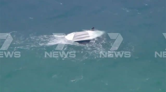 The men held onto the overturned boat. Source: 7 News