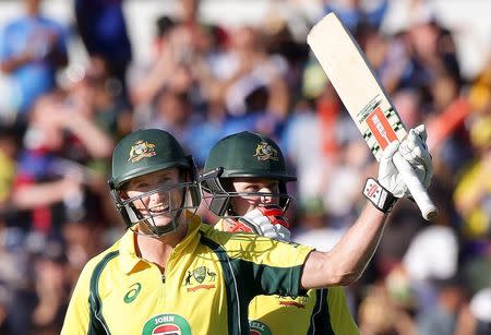 Australia's George Bailey (L) celebrates with team mate Steve Smith after making his century during the One Day International cricket match against India in Perth January 12, 2016. REUTERS/Bill Hatto