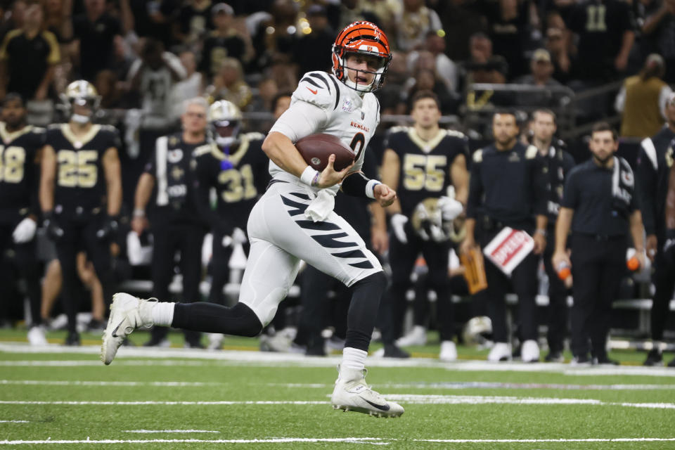 Cincinnati Bengals quarterback Joe Burrow (9) runs for a touchdown against the New Orleans Saints during the first half of an NFL football game in New Orleans, Sunday, Oct. 16, 2022. (AP Photo/Butch Dill)