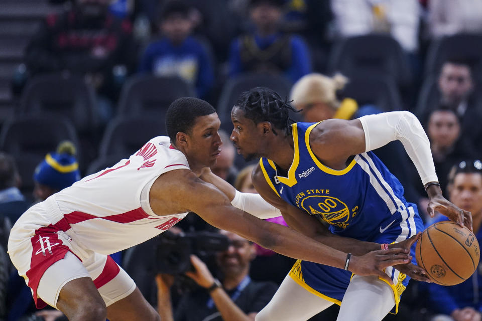 Houston Rockets forward Jabari Smith Jr., left, pokes the ball away from Golden State Warriors forward Jonathan Kuminga during the first half of an NBA basketball game in San Francisco, Friday, Feb. 24, 2023. (AP Photo/Godofredo A. Vásquez)