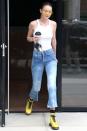 <p>In yellow aviators, a white tank, distressed denim, yellow boots and holding a Furla Micro Jungle Bag leaving her apartment in New York. </p>