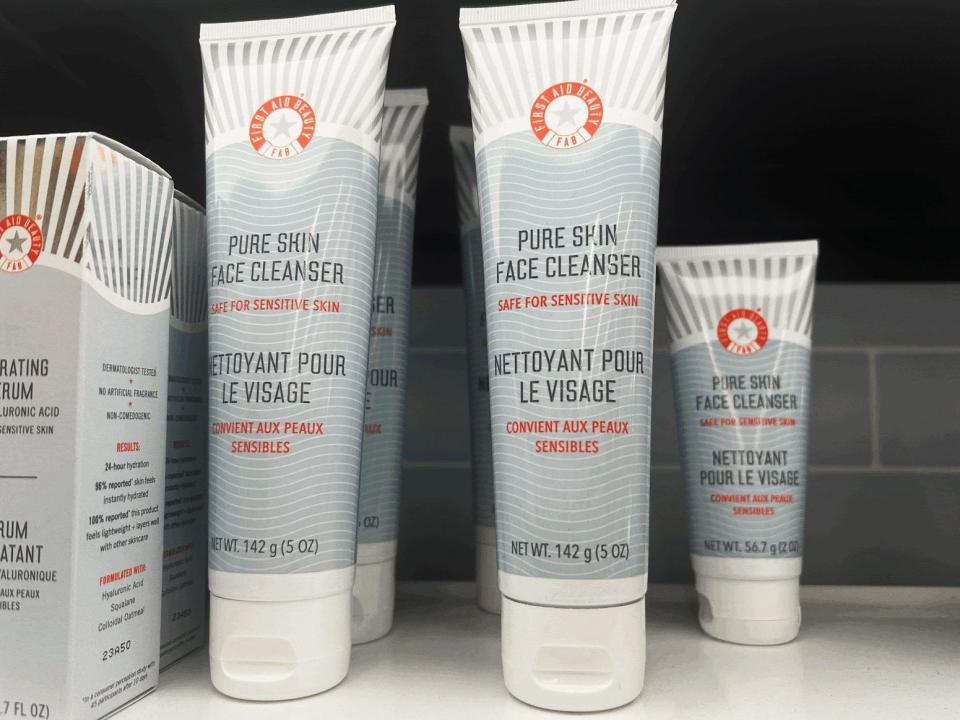 Blue and white tubes of First Aid Beauty pre skin face cleansers on shelves at Sephora