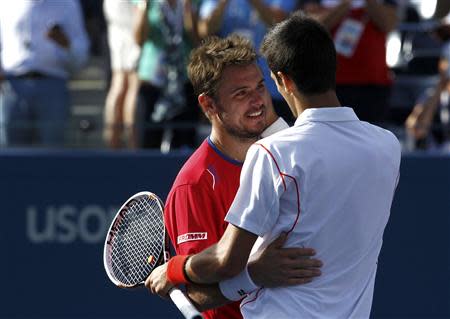 Novak Djokovic of Serbia is congratulated by Stanislas Wawrinka of Switzerland (L) after Djokovic won their men's semi-final match at the U.S. Open tennis championships in New York September 7, 2013. REUTERS/Eduardo Munoz