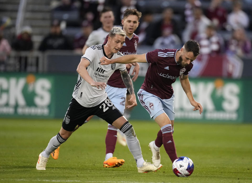 Colorado Rapids defender Keegan Rosenberry, right, tries to collect the ball as San Jose Earthquakes forward Benji Kikanovic defends during the first half of an MLS soccer match Saturday, June 3, 2023, in Commerce City, Colo. (AP Photo/David Zalubowski)