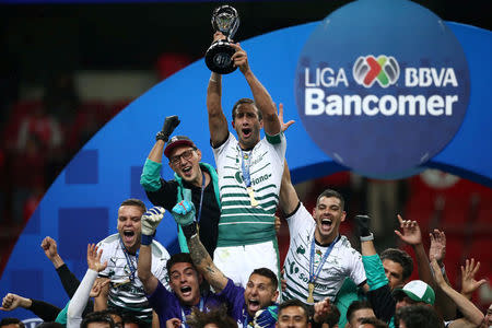 Football Soccer - Mexican First Division Final Second Leg - Toluca v Santos Laguna - Nemesio Diez stadium, Toluca, Mexico May 20, 2018. Carlos Izquierdoz of Santos Laguna holds up the trophy after winning the Mexican First Division Final. REUTERS/Edgard Garrido