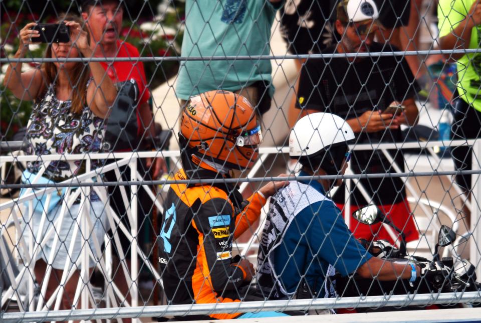 Driver Lando Norris of the McLaren Formula 1 Team is given a ride back to the garage after crashing his car Sunday during the Formula 1 Crypto.com Miami Grand Prix in Miami Gardens. Norris was one of three drivers who didn't finish the race.