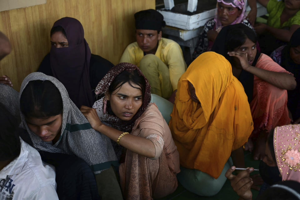 Rohingya refugees rescued from a capsized boat rest at a temporary shelter upon arrival at a port in Meulaboh, Indonesia, Thursday, March 21, 2024. An Indonesian search and rescue ship on Thursday located a capsized wooden boat that had been carrying dozens of Rohingya Muslim refugees, and began pulling survivors who had been standing on its hull to safety. (AP Photo/Reza Saifullah)