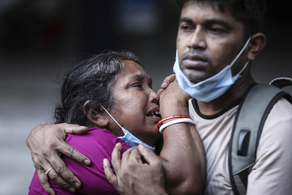 A Bangladeshi woman mourns the death of her husband who died of COVID-19 at a hospital in Dhaka, Bangladesh, Friday, May 7, 2021. India's surge in coronavirus cases is having a dangerous effect on neighboring Bangladesh. Health experts warn of imminent vaccine shortages just as the country should be stepping up its vaccination drive, and as more contagious virus variants are beginning to be detected. (AP Photo/Mahmud Hossain Opu)