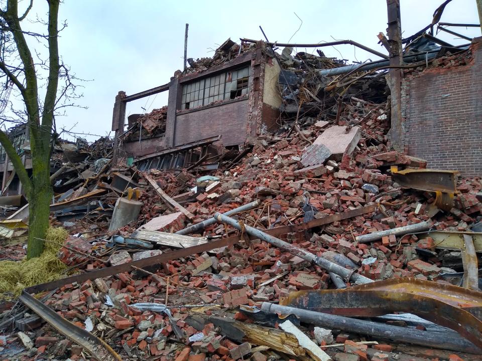 Shattered bricks are scattered along River Street on Saturday, Jan. 27, 2024, as demolition continues at the former Goodyear Tire & Rubber Co. mixing center in Akron, Ohio.