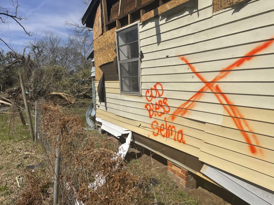 A home damaged by last month's tornado stands in Selma, Ala., Tuesday, Feb. 14, 2023. A month after a tornado ravaged historic Selma, a city etched in the history of the civil rights movement, residents and city officials say they are bracing for a long recovery. (AP Photo/Kim Chandler)