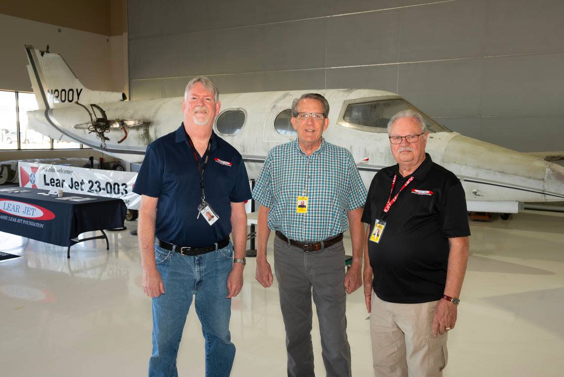 Bill Kinkaid, left, Chris Marshall, center, and Rick Rowe, helped form the Classic Lear Jet Foundation to acquire and restore the plane behind them, the first Learjet sold in 1964. The foundation has now purchased the plane for $90,000.
