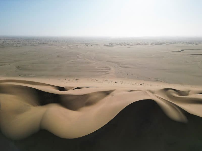 A drone view of Dune 7 and a desert in the background in Walvis Bay