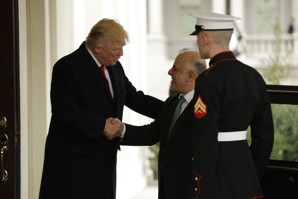 President Donald Trump greets Iraqi Prime Minister Haider al-Abadi upon his arrival to the White House in Washington, Monday, March 20, 2017. (AP Photo/Evan Vucci)