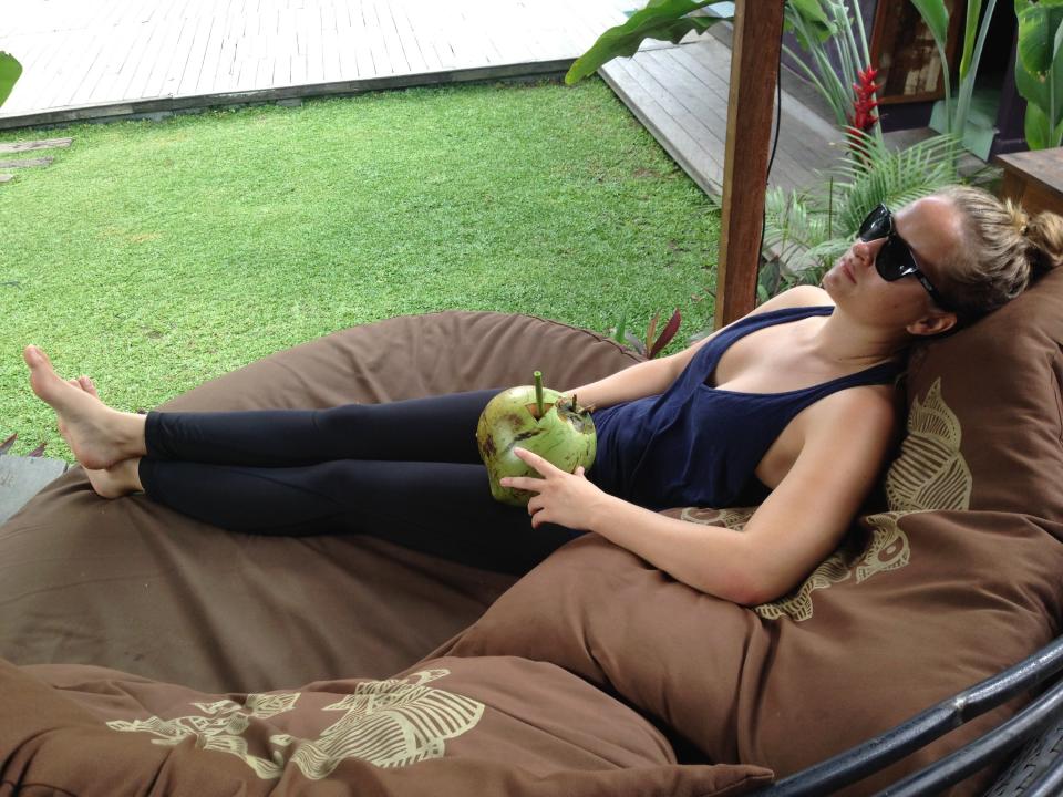 Woman sitting on chair with coconut water