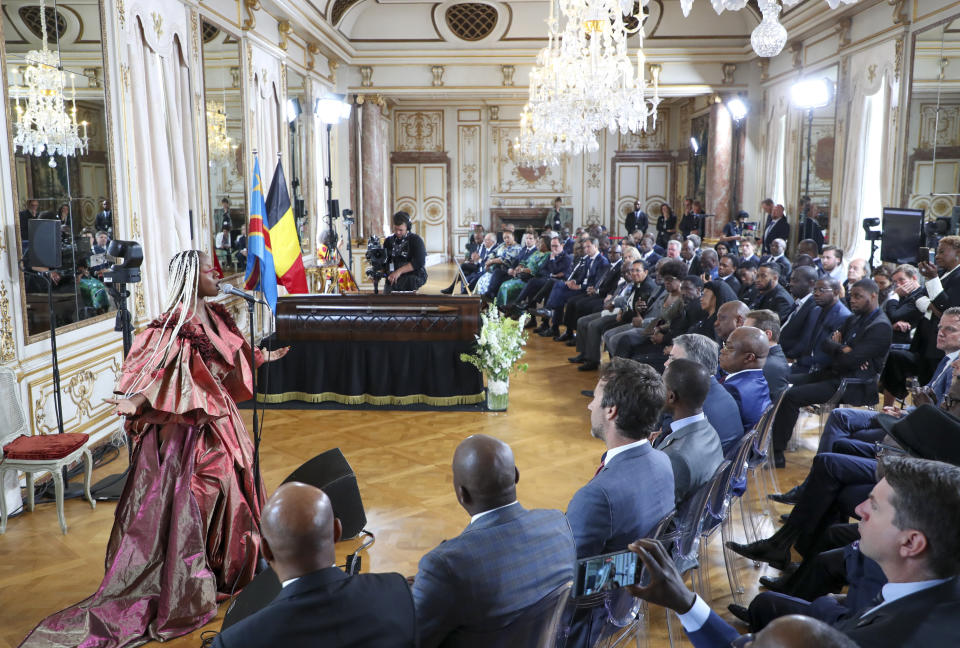 A performer sings during a ceremony to return the remains of Patrice Lumumba to his family at the Egmont Palace in Brussels, Monday, June 20, 2022. On Monday, more than sixty one years after his death, the mortal remains of Congo's first democratically elected prime minister Patrice Lumumba were handed over to his children during an official ceremony in Belgium. (Nicholas Maeterlinck, Pool Photo via AP)