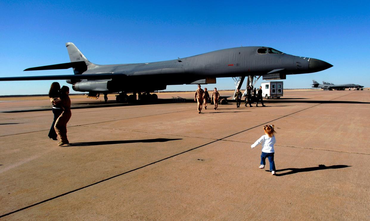 McKenzie Weber, 2, runs to her father, Air Force Captain Brad Weber as another 9th Bomb Squadron crewman from the same B-1B greets a loved one Friday, Jan.18, 2008 at Dyess Air Force Base. For 70 years, families and Abilene have welcomed airmen as a vital part of the community.