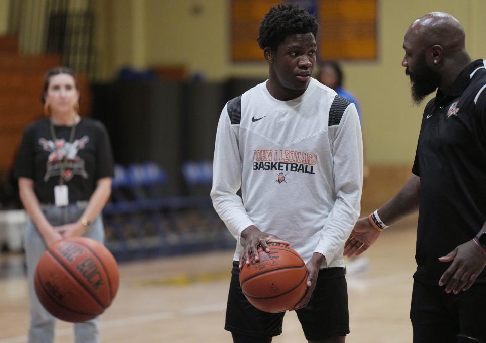 Lovinske Louis #15 communicates with heat coach Eddie Tolliver during warm-ups before the game against Cardinal Newman on Friday, January 12, 2024 in West Palm Beach.