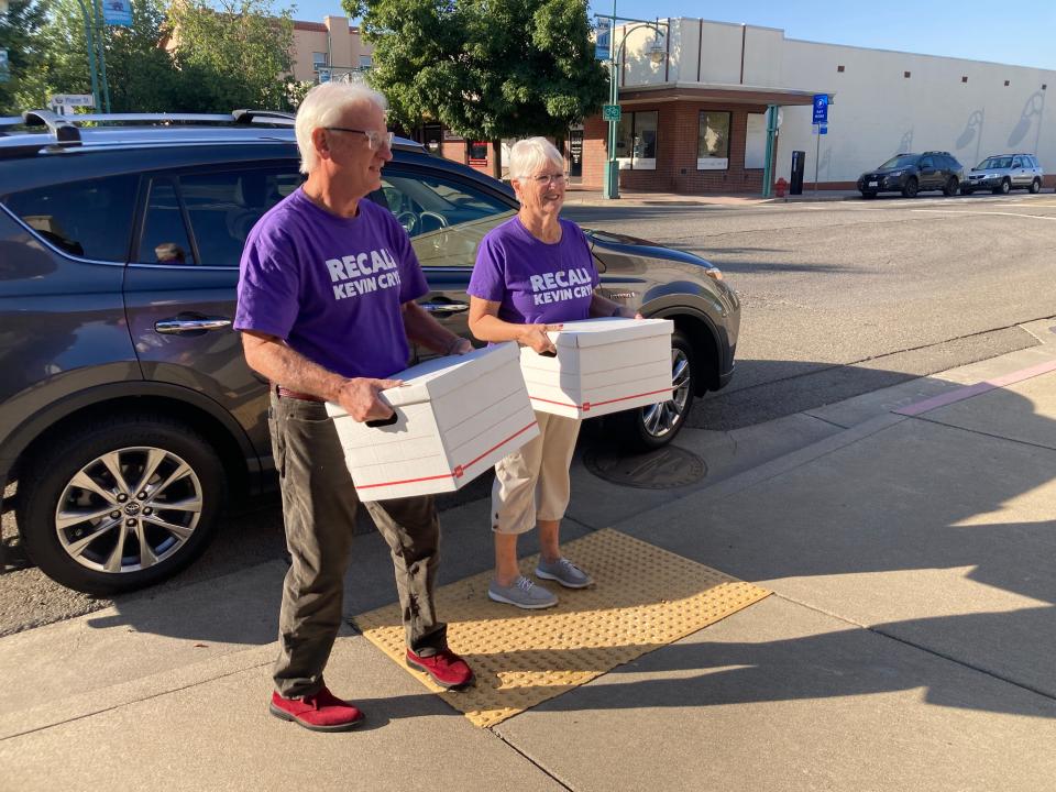 Max Walter, left, and Judy Menoher walk to the Shasta County elections office on Tuesday, Sept. 12, 2023, with the boxes of signatures that were collected in support of recalling Supervisor Kevin Crye.