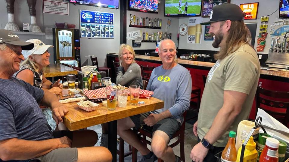 Joshua Hatch, owner of Jaxx Sports Bar & Grill, 1035 Hasko Road, Palmetto, visits with guests Candy and Todd Ringling and Karen and Keith Middendorf.