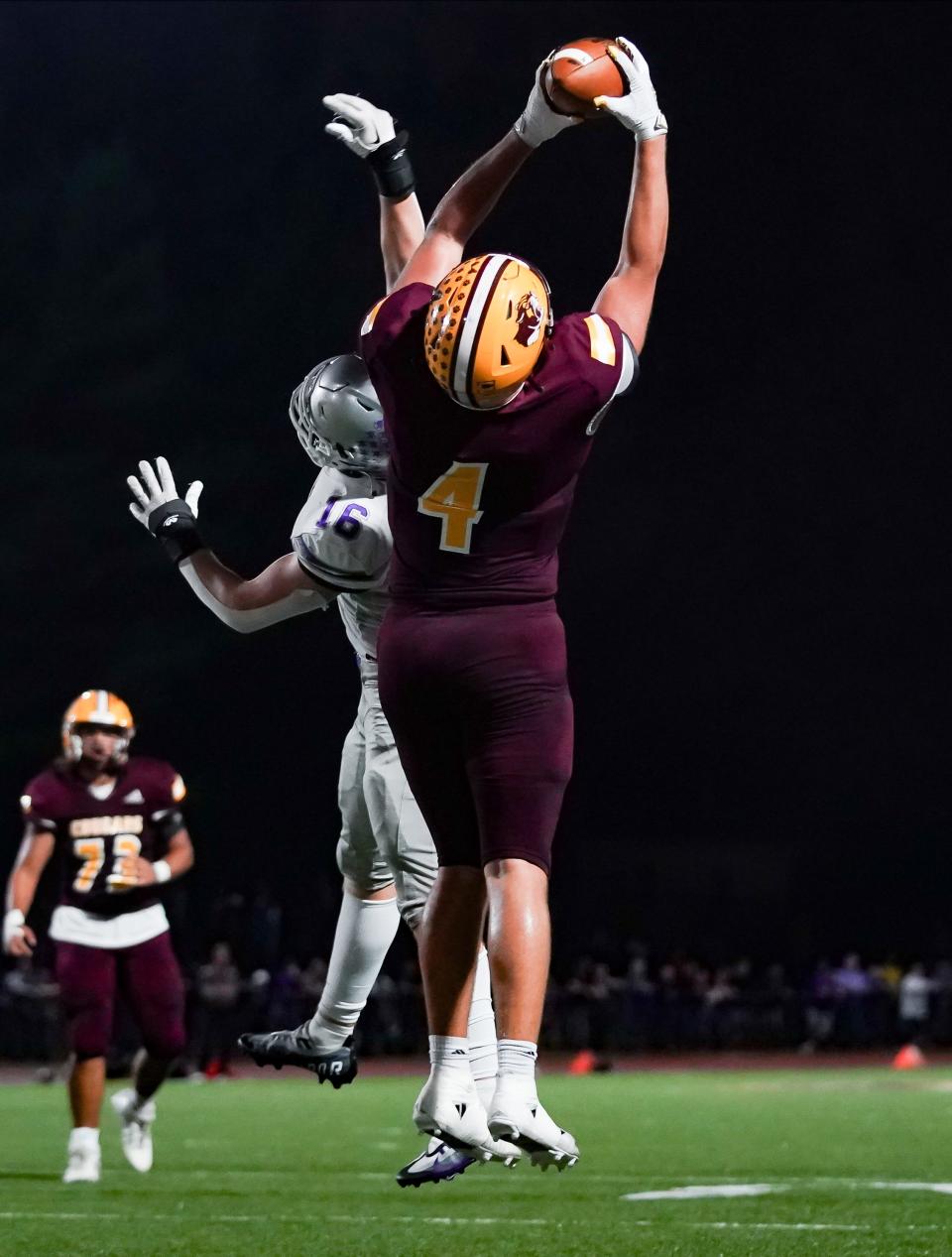 Bloomington North’s Aidan Steinfeldt (4) catches a pass over Bloomington South’s Ben Godar (16) during the IHSAA sectional semi-final football game at Bloomington North on Friday, Oct. 27, 2023.