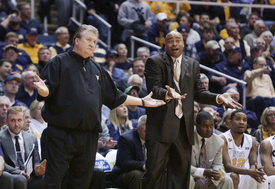 West Virginia  coach Bob Huggins and assistant coach Erik Martin question their team's play during the second half of an NCAA college basketball game against Oklahoma, Tuesday, Jan. 13, 2015, in Morgantown, W.Va. West Virginia defeated Oklahoma 86-65.