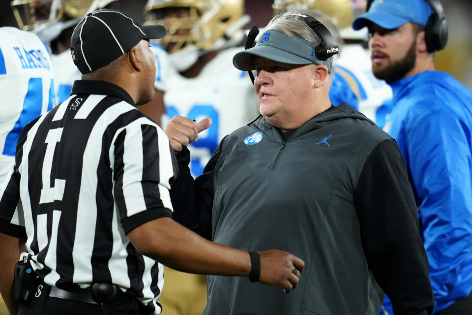 UCLA coach Chip Kelly talks with an official during the first half of the team's NCAA college football game against Arizona State in Tempe, Ariz., Saturday, Nov. 5, 2022. (AP Photo/Ross D. Franklin)