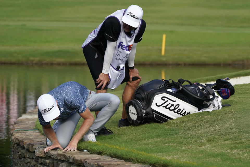 Will Zalatoris, left, looks at his tee shot on the 11th green during a playoff in the final round of the St. Jude Championship golf tournament, Sunday, Aug. 14, 2022, in Memphis, Tenn. (AP Photo/Mark Humphrey)