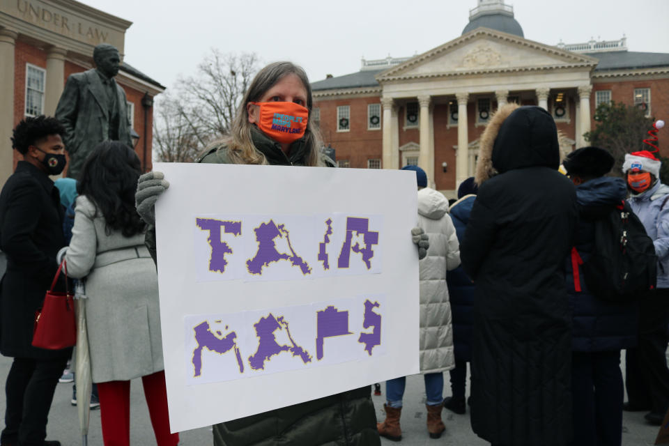 FILE - Amanda SubbaRao holds a sign calling for "Fair Maps" during a rally in Annapolis, Md., on Dec. 8, 2021. Campaigns for Congress already are underway for this year's elections, but lingering disagreements over the final shape of new voting districts has left some candidates, and would-be candidates, in limbo. A few states have yet to enact new congressional districts following the 2020 census and some had their maps struck down by courts. (AP Photo/Brian Witte, File)