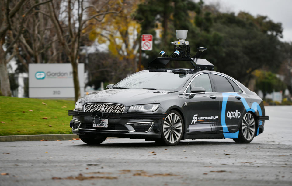 A Baidu Apollo self-driving car outfitted with a host of sensors on the roof.