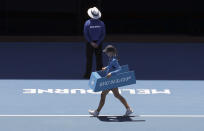 FILE In this Jan. 22, 2019 file photo, A line judge crosses the court during a break in the quarterfinal between Spain's Roberto Bautista Agut and Greece's Stefanos Tsitsipas at the Australian Open tennis championships in Melbourne, Australia. In a Grand Slam-first, at the 2021 Australian Open tennis championships, there will be no on-court line judges on any of the tournament courts in an effort to reduce the number of staff on-site due to coronavirus-related concerns. Only chair umpires and ball persons will be on the court. (AP Photo/Aaron Favila,File)