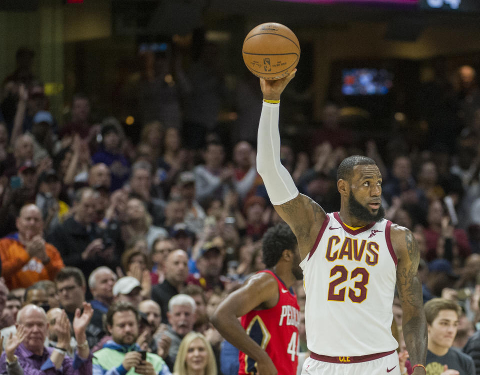Cleveland Cavaliers’ LeBron James celebrates during the first half of an NBA basketball game against the New Orleans Pelicans in Cleveland, Friday, March 30, 2018. James broke Michael Jordan’s NBA record by scoring at least 10 points in his 867th straight regular-season game. (AP Photo/Phil Long)