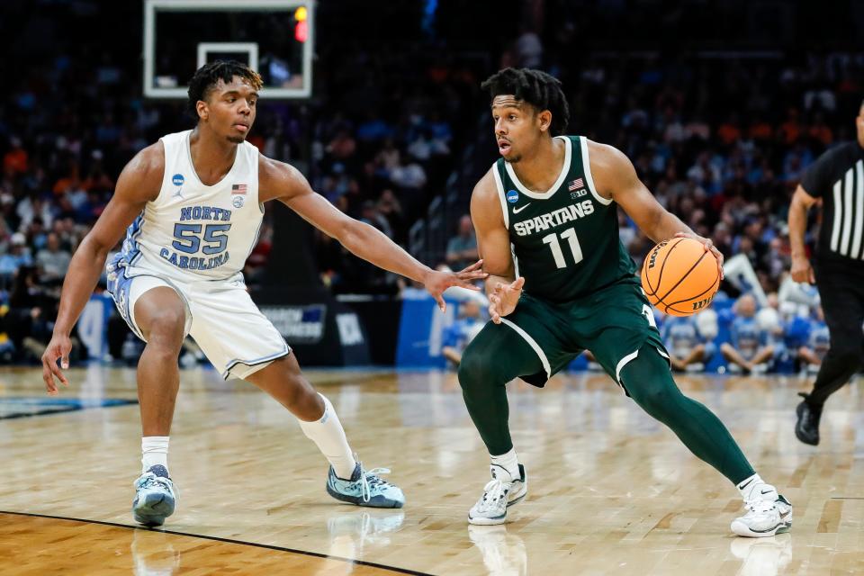 Michigan State guard AJ Hoggard (11) dribbles past North Carolina forward Harrison Ingram (55) during the second half of the second round of the NCAA Tournament West Region at the Spectrum Center in Charlotte, NC, on Saturday, March 23, 2024.